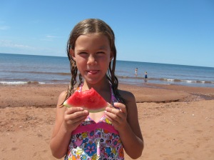 Enjoying watermelon on the beach